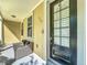Inviting entryway featuring a dark front door and a comfortable wicker bench at 4584 Virginia Dr, Orlando, FL 32814