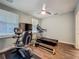 Bright exercise room with hardwood floors, a ceiling fan, and a variety of exercise equipment at 4584 Virginia Dr, Orlando, FL 32814