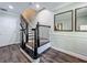 Elegant foyer featuring hardwood floors, ornate staircase, and decorative mirrors at 4584 Virginia Dr, Orlando, FL 32814