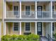 Welcoming front porch and second-story balcony with white columns and outdoor seating at 4584 Virginia Dr, Orlando, FL 32814
