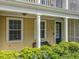 Charming front porch with cozy seating area and classic architectural details at 4584 Virginia Dr, Orlando, FL 32814