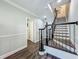 Bright hallway features wood-look floors, staircase with decorative black railing, and access to other rooms at 4584 Virginia Dr, Orlando, FL 32814
