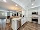 Bright kitchen with stainless steel appliances, island and sightlines to dining room at 4584 Virginia Dr, Orlando, FL 32814