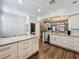 Open kitchen with marble countertops, stainless steel appliances, white cabinetry, and wood look floors at 4584 Virginia Dr, Orlando, FL 32814