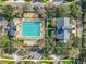 Aerial view of a pristine swimming pool area with lounge chairs and lush landscaping at 4584 Virginia Dr, Orlando, FL 32814