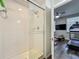 Modern walk-in shower with white tile and glass door, located near the exercise room at 4584 Virginia Dr, Orlando, FL 32814