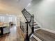 Elegant staircase with dark wood floors and ornate wrought iron railings, leading to the upper level at 4584 Virginia Dr, Orlando, FL 32814