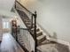 Carpeted staircase with dark wood railing at 4584 Virginia Dr, Orlando, FL 32814