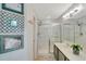 Well-lit bathroom featuring a shower with glass doors, a sink, and decorative wall art at 486 Shirley Dr, Apopka, FL 32712