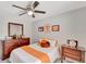 Cozy bedroom featuring a ceiling fan, matching furniture and playful Tennessee Volunteers decor and memorabilia at 486 Shirley Dr, Apopka, FL 32712