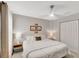 Relaxing bedroom featuring neutral colors, soft bedding, a ceiling fan, and closet at 486 Shirley Dr, Apopka, FL 32712