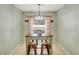 Charming dining room with modern light fixture, a wooden table set, and stylish curtains that filter natural light at 486 Shirley Dr, Apopka, FL 32712