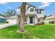 Beautiful two-story home featuring an inviting front porch, well-maintained lawn, and tasteful landscaping at 486 Shirley Dr, Apopka, FL 32712