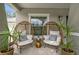 Cozy front porch with comfortable egg chairs, stylish side table, and inviting greenery at 486 Shirley Dr, Apopka, FL 32712