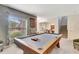 Spacious game room with a wooden pool table, cozy seating, and stylish decor at 486 Shirley Dr, Apopka, FL 32712