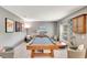 Spacious game room with a wooden pool table, cozy seating, and stylish decor at 486 Shirley Dr, Apopka, FL 32712