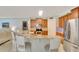 Kitchen featuring granite countertops, wood cabinets, stainless steel appliances, and a breakfast bar with seating at 486 Shirley Dr, Apopka, FL 32712