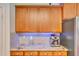 Kitchen featuring wooden cabinets, granite countertops, a stainless steel refrigerator, and a silver espresso machine at 486 Shirley Dr, Apopka, FL 32712