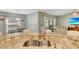 Kitchen features granite countertops, stainless steel sink, and an open view to the dining area and living room at 486 Shirley Dr, Apopka, FL 32712