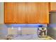 Kitchen featuring wooden cabinets, granite countertops, a stainless steel refrigerator, and a silver espresso machine at 486 Shirley Dr, Apopka, FL 32712