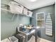 Laundry room featuring dark gray cabinets, appliances, and overhead shelf for organizing essential items at 486 Shirley Dr, Apopka, FL 32712