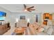 Bright living room with tile flooring, ceiling fan, and comfortable seating with an open view to the kitchen at 486 Shirley Dr, Apopka, FL 32712