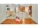 Open concept layout connecting the dining and living rooms, featuring hardwood floors and neutral color palette at 486 Shirley Dr, Apopka, FL 32712