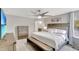 Comfortable main bedroom with neutral colors, a ceiling fan, and a bench at the foot of the bed at 486 Shirley Dr, Apopka, FL 32712