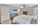 Bright main bedroom with neutral tones, a ceiling fan, and a view of the attached bathroom at 486 Shirley Dr, Apopka, FL 32712