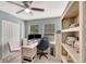 Bright home office with dual monitors, light-colored desk and shelving, and a gray carpet at 486 Shirley Dr, Apopka, FL 32712