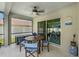 An inviting screened-in patio featuring a wooden table and blue chairs, perfect for outdoor dining at 486 Shirley Dr, Apopka, FL 32712