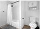Clean bathroom featuring a shower-tub combo and white tiled walls at 531 Wigman Dr, Eatonville, FL 32751