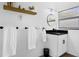 Bright bathroom featuring a modern vanity with black hardware, round mirror, and stylish decor at 531 Wigman Dr, Eatonville, FL 32751
