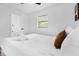 Bedroom featuring a comfortable bed, white linens, and view of the ensuite bathroom at 531 Wigman Dr, Eatonville, FL 32751