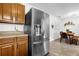 Modern kitchen with stainless steel refrigerator and a view into the dining area at 531 Wigman Dr, Eatonville, FL 32751