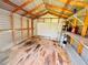 Interior view of the shed showing a pegboard, wooden beams, and wire shelving for optimal garden storage and organization at 531 Wigman Dr, Eatonville, FL 32751