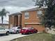 Two-story tan home with an attached two-car garage and driveway parking at 547 Big Sioux Ct, Kissimmee, FL 34759