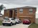 Two-story tan home with an attached two-car garage and driveway parking at 547 Big Sioux Ct, Kissimmee, FL 34759