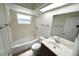 Bathroom features new tile in the shower, bathtub, and single sink vanity at 5472 E Grant St, Orlando, FL 32812