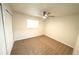Bedroom with neutral carpet, window, and ceiling fan at 5472 E Grant St, Orlando, FL 32812
