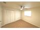 Bedroom with neutral carpet, a window, ceiling fan, and built-in closet at 5472 E Grant St, Orlando, FL 32812