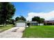 Charming single-story home with a well-maintained lawn and concrete driveway at 5472 E Grant St, Orlando, FL 32812