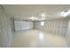 Spacious two-car garage with white walls, ceiling, and epoxy floor at 5472 E Grant St, Orlando, FL 32812