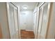 Hallway features hardwood floors, white doors, and overhead lighting at 5472 E Grant St, Orlando, FL 32812