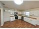 Bright kitchen with stainless steel appliances, wood countertops, and white cabinets at 5472 E Grant St, Orlando, FL 32812