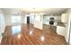 Open-concept living room and kitchen area featuring wood floors and natural light at 5472 E Grant St, Orlando, FL 32812