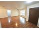 Bright living room features wood floors, lots of light, and a ceiling fan at 5472 E Grant St, Orlando, FL 32812