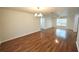 Open concept living room and dining area with hardwood floors at 5472 E Grant St, Orlando, FL 32812