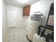Utility room with a water heater and some storage at 5472 E Grant St, Orlando, FL 32812