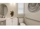 Accessible bathroom with a sleek pedestal sink, grab bars and modern fixtures at 5626 Portico Pl, Kissimmee, FL 34758